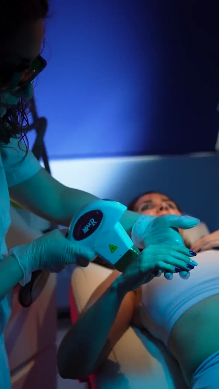 Ghazaleh treating the underarm area with a laser handpiece